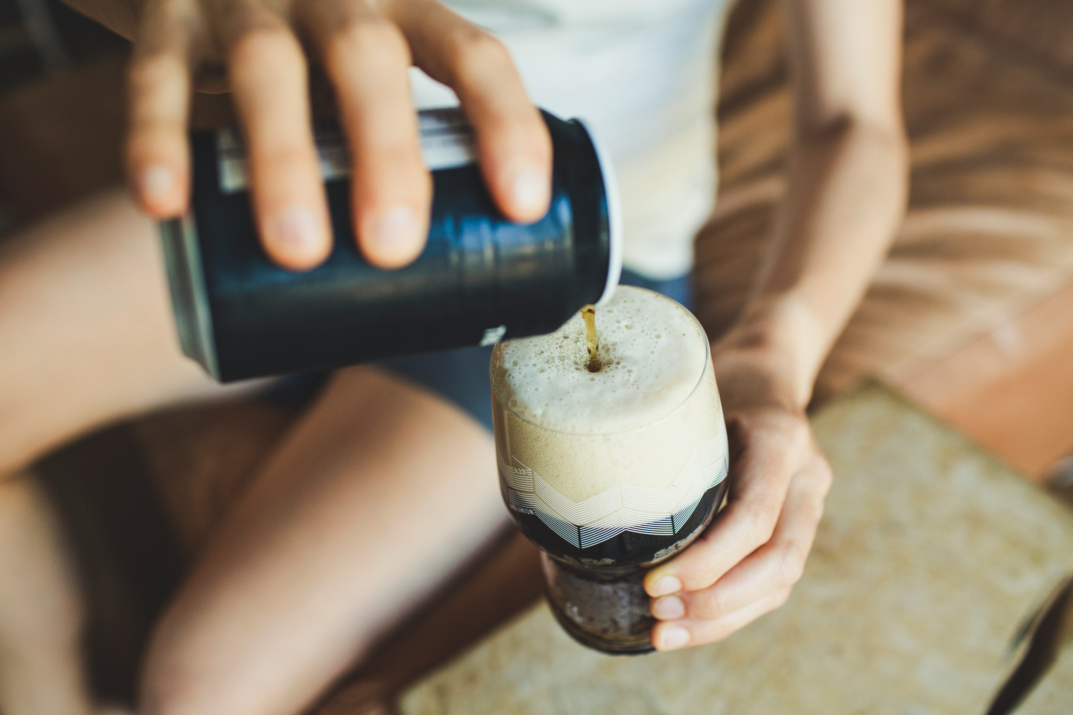 person holding black and white plastic bottle